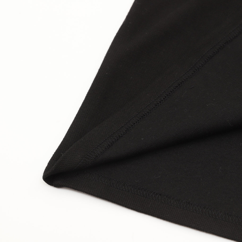 AMI Paris Long-Sleeve Polo Shirt — Tonal Heart Logo, Black | FW25
